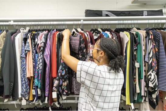 Student picking clothes out of Career Closet