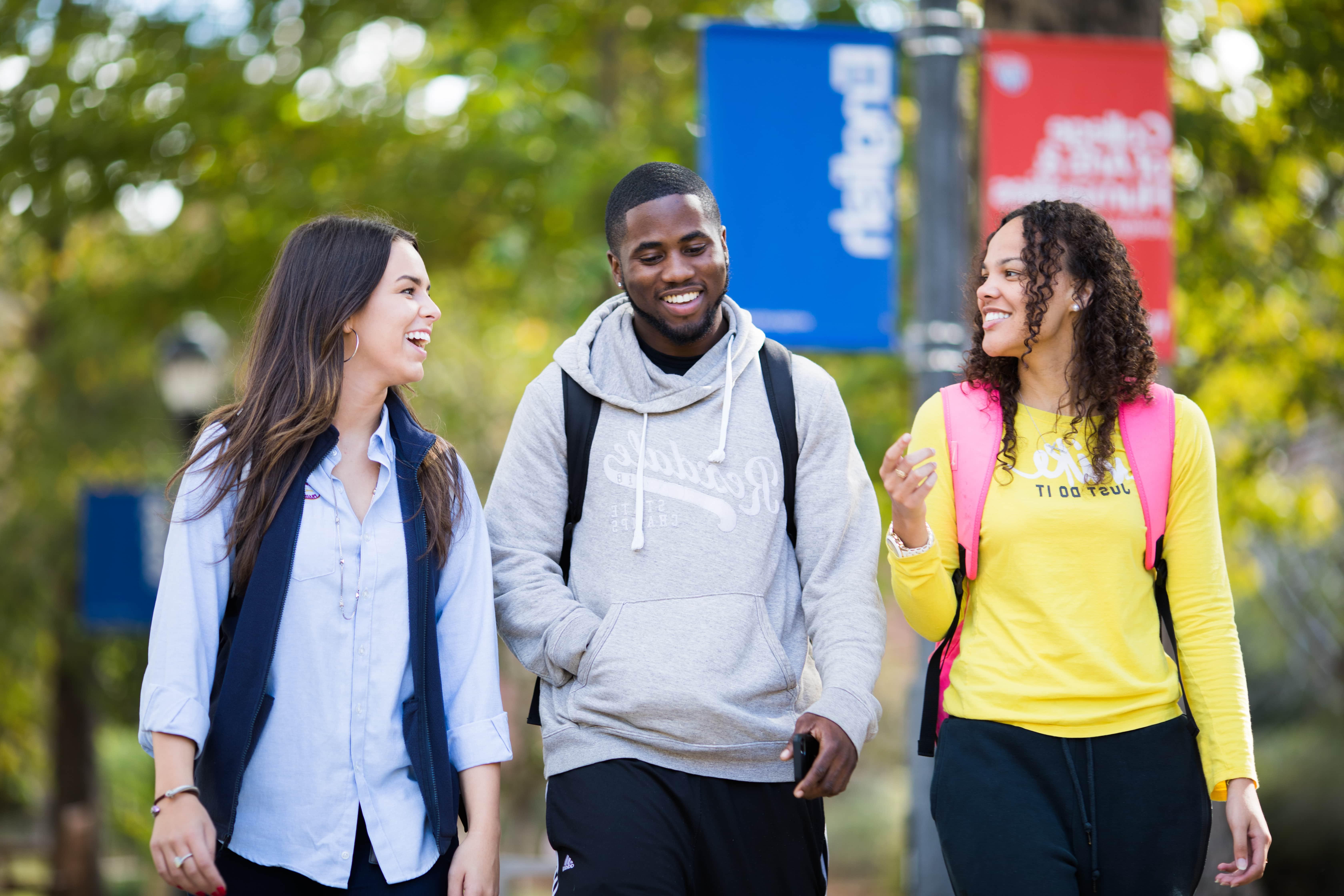 Three students walking through campus.